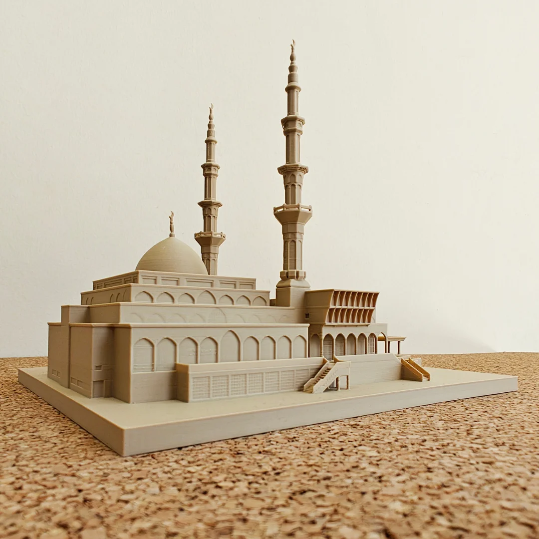 Opposite side view of a King Faisal Mosque model showing its dome and arched facade.
