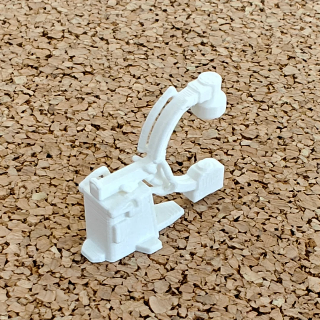 Miniature C-arm X-ray machine model at 1:50 scale.
