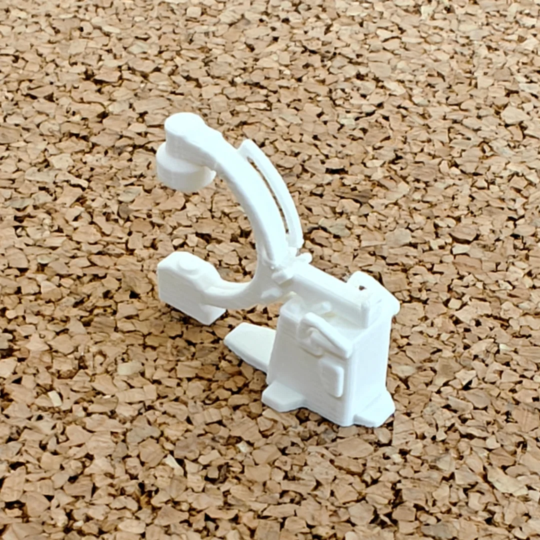 Miniature C-arm X-ray machine model at 1:50 scale.