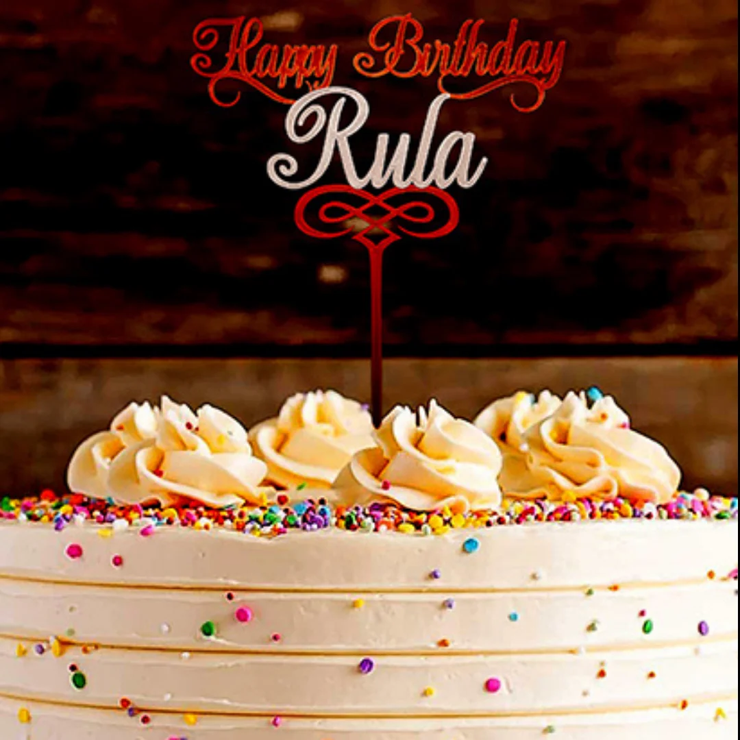 Happy Birthday Rula cake topper with decorative scrollwork displayed on a cake.