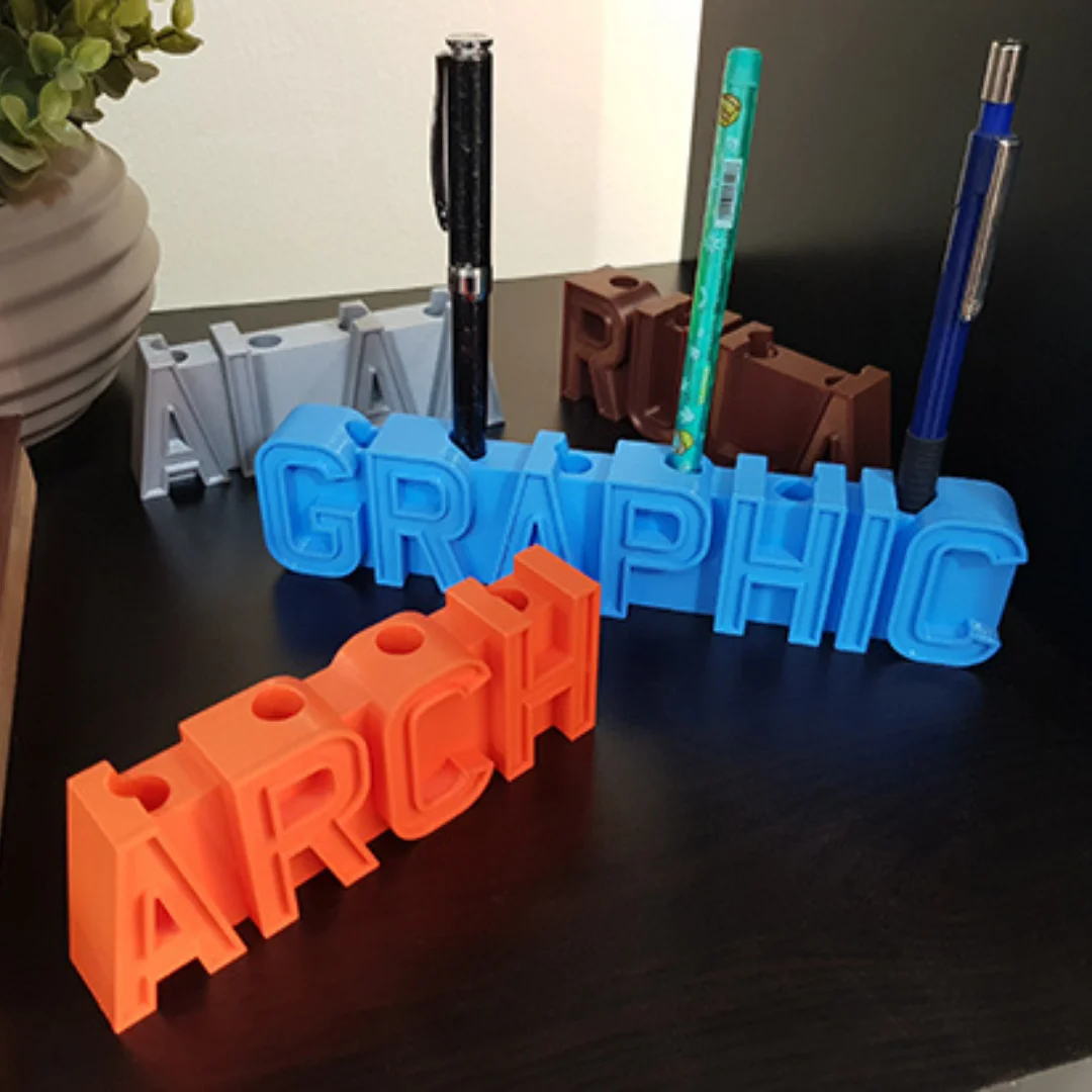 3D printed name pen holders with upright pens inserted into the raised lettering.