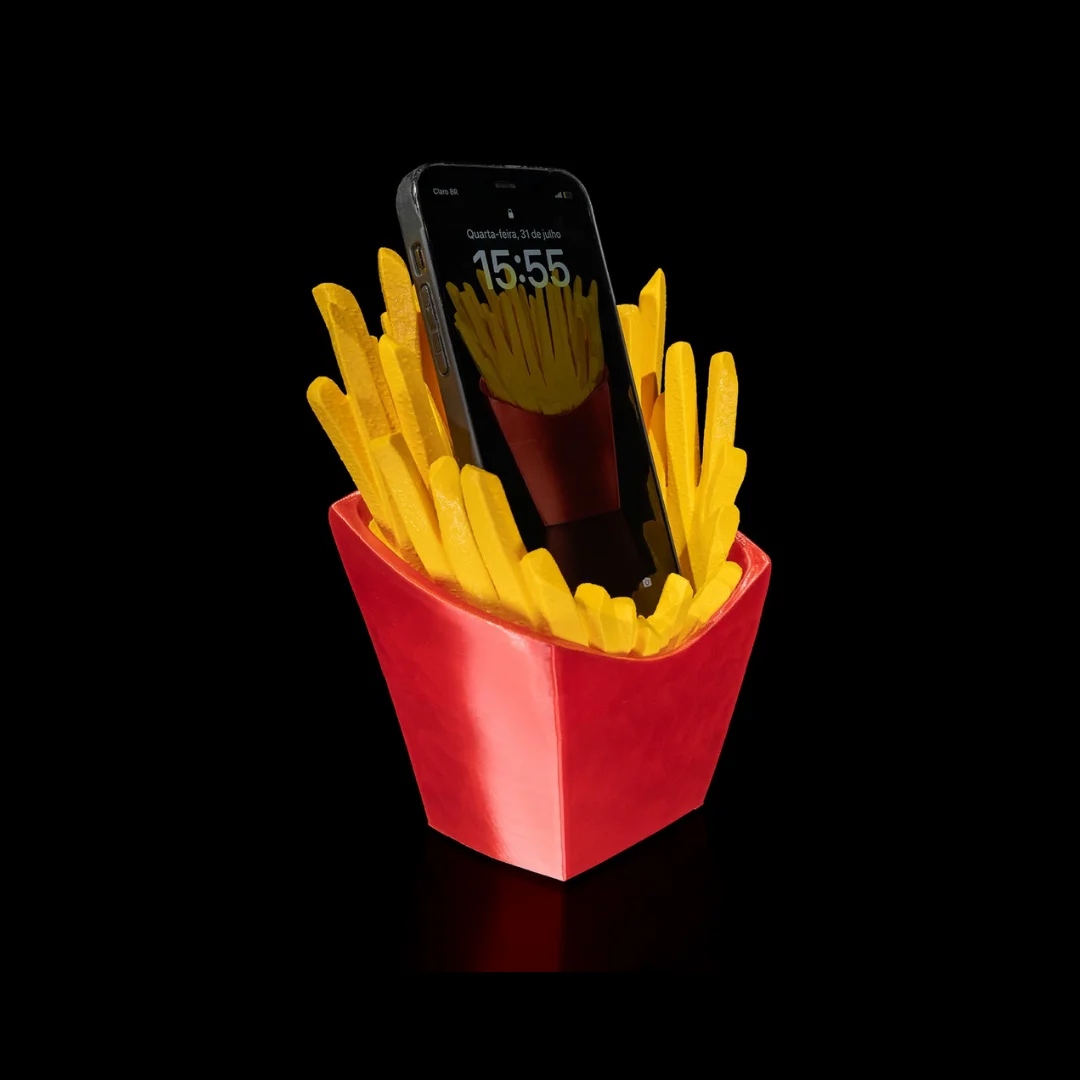 Angled view of a smartphone resting in a French fries carton phone holder.