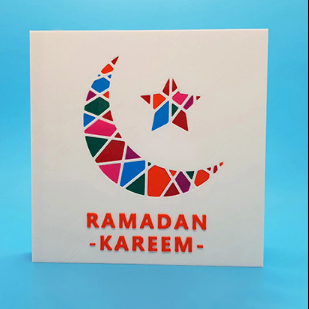 Front view of a Ramadan Kareem card with geometric crescent and star decoration.