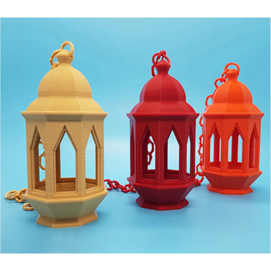 Close view of three Ramadan lanterns showing pointed arch openings and 3D printed surface texture.