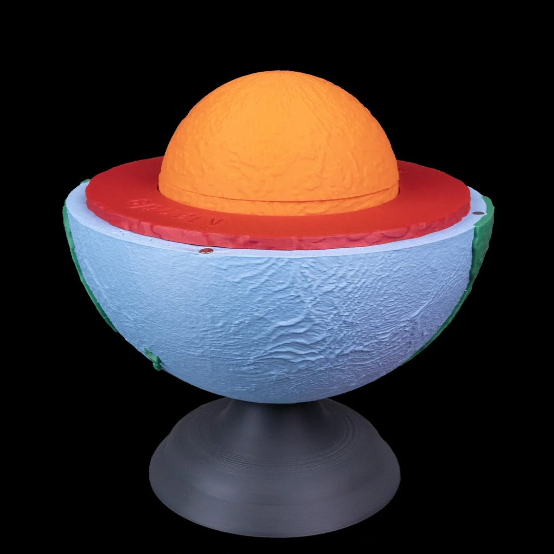 Earth layers model with the upper shell removed to expose a raised inner layer.
