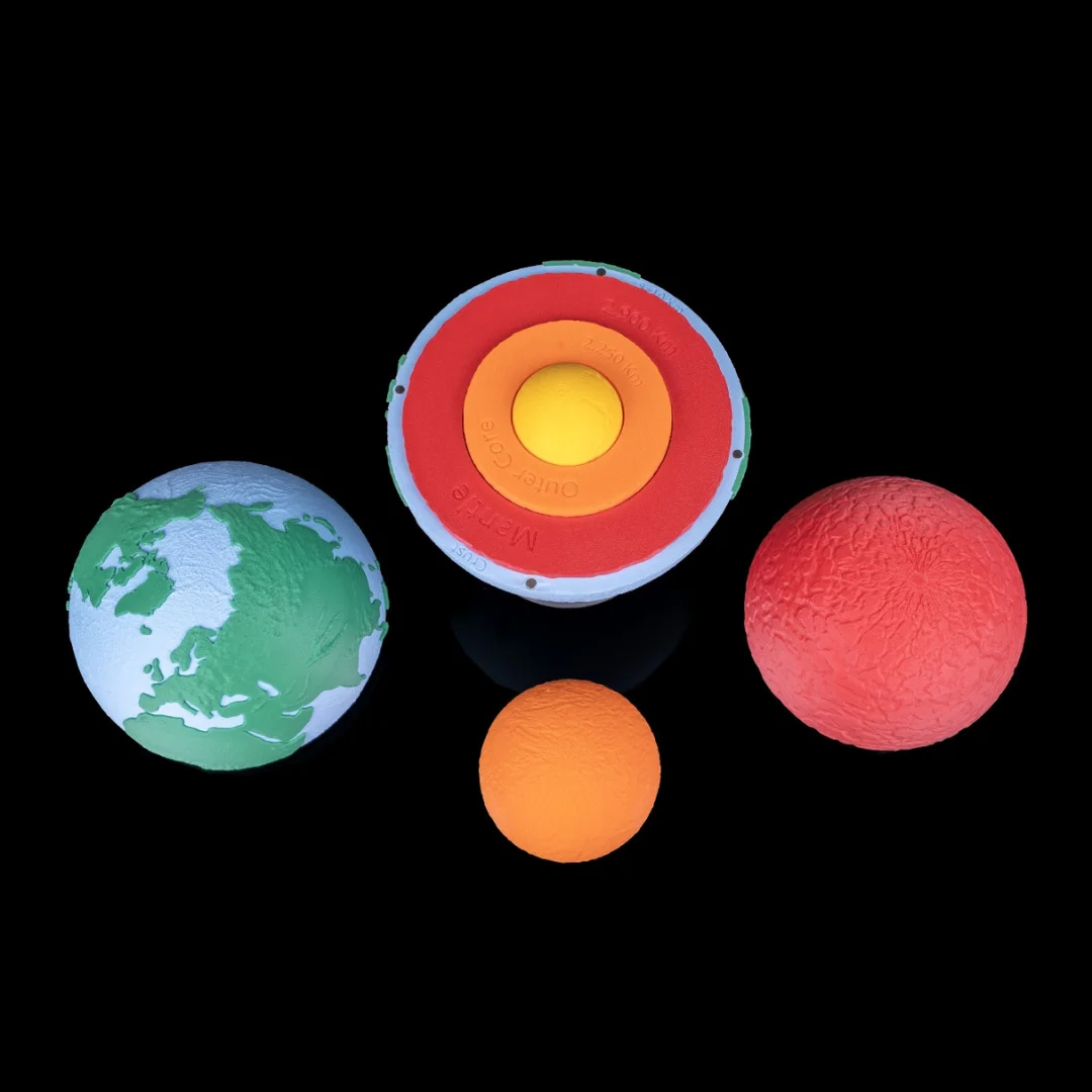 Disassembled Earth layers model with the outer shell and inner pieces beside it.