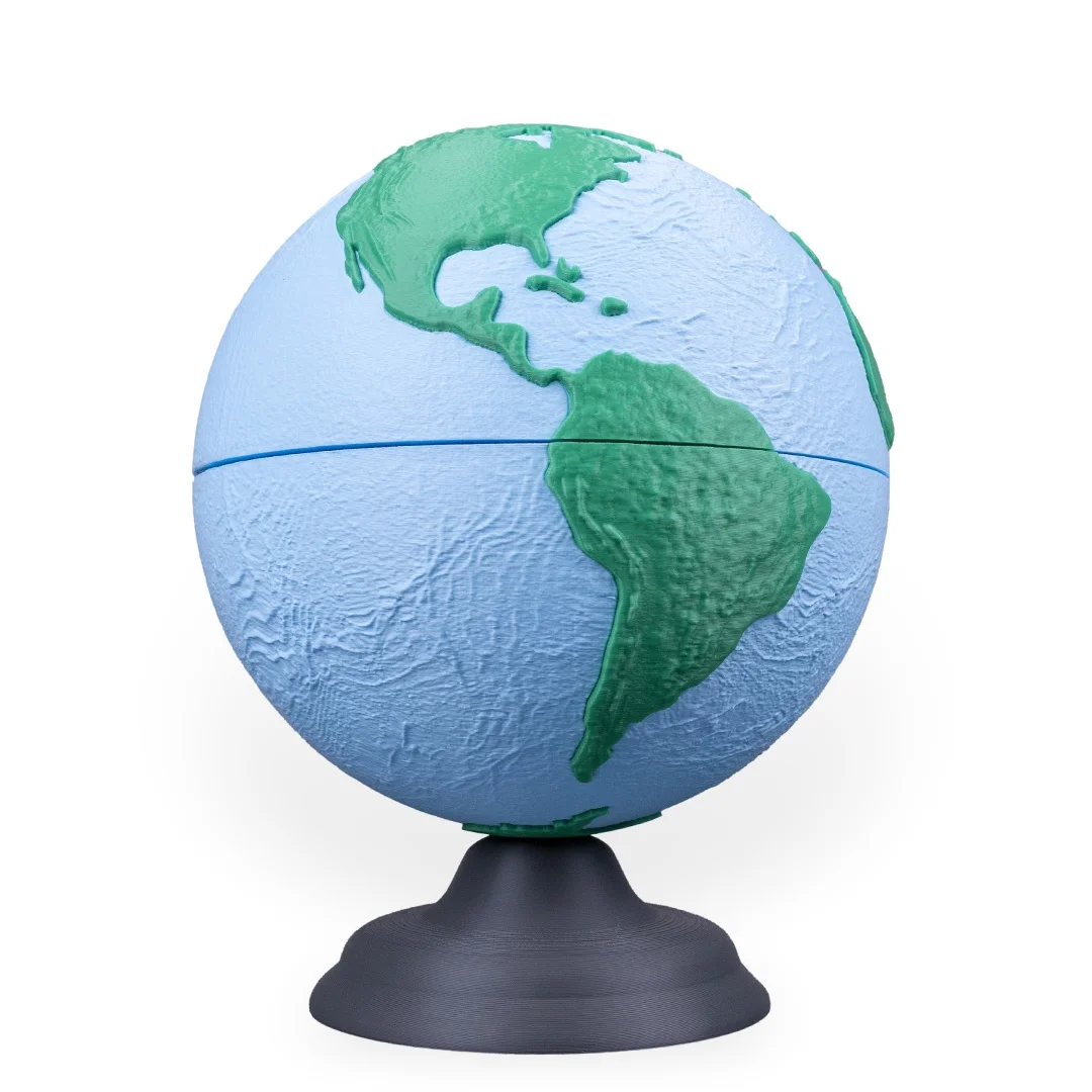 Earth globe model on a stand with the Americas facing forward.