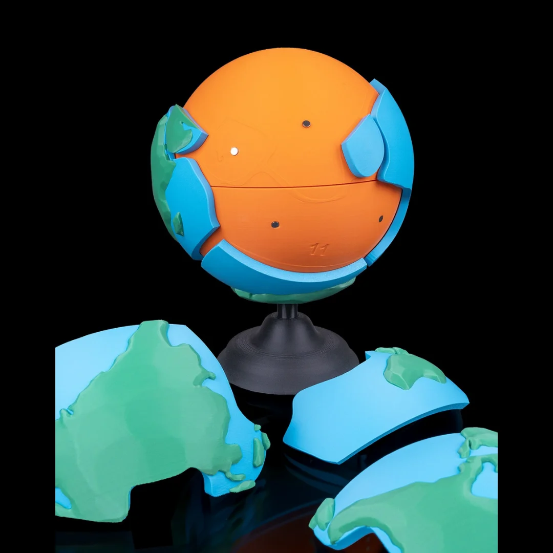 Partly disassembled Earth puzzle showing its inner sphere and detached pieces.