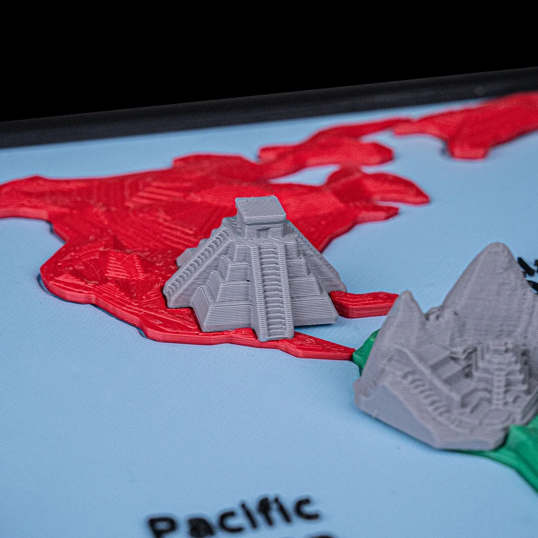Close view of a stepped pyramid miniature on the world map model.