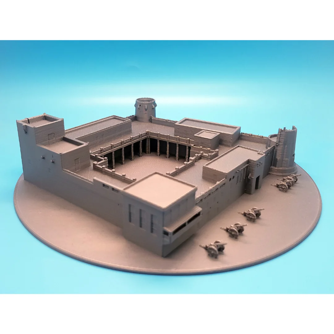 Elevated view of a Sharjah Fort model on a circular base with small cannon details.
