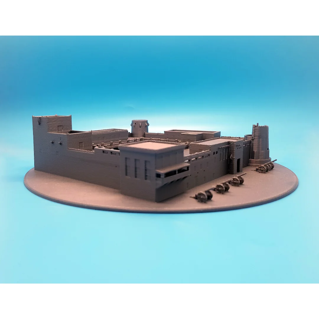 Low angled view of a Sharjah Fort model and its circular display base.