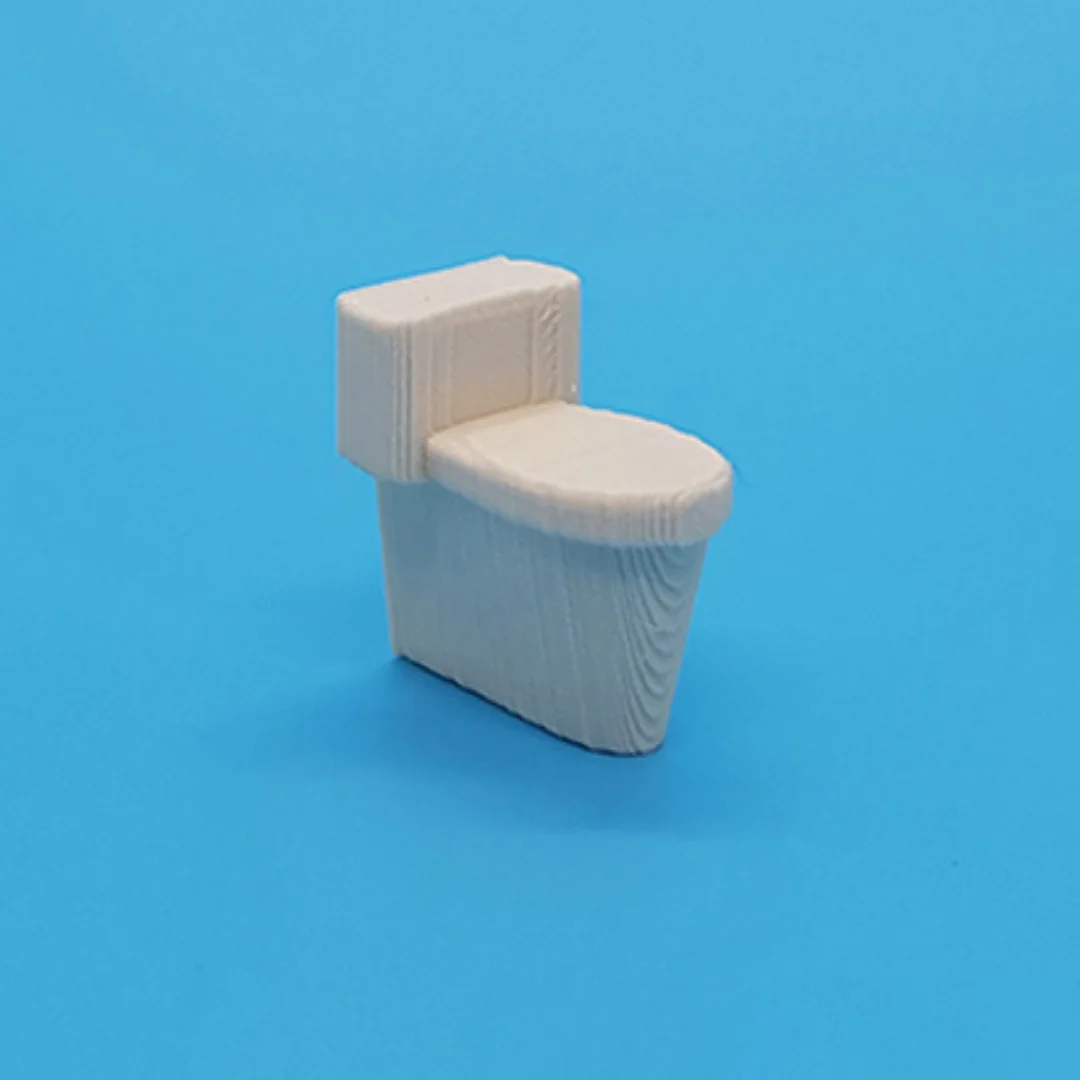 Miniature toilet model at 1:50 scale.