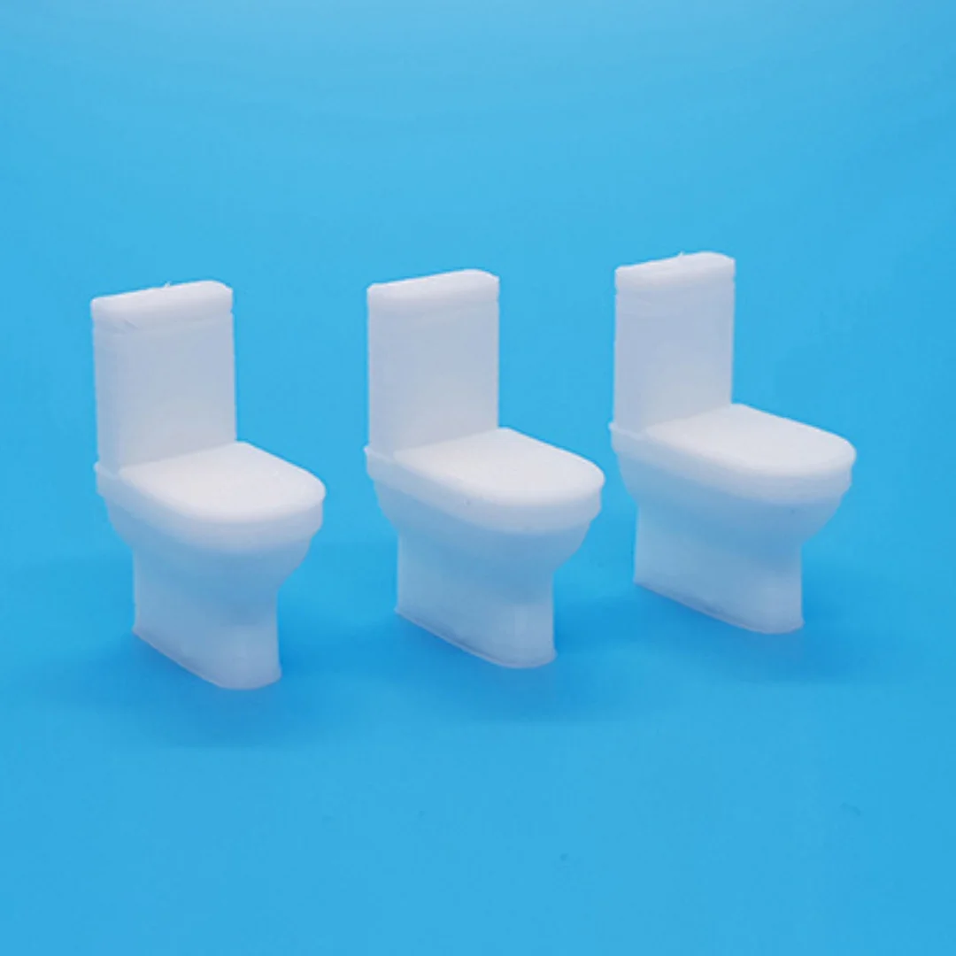 Miniature toilet models displayed together at 1:50 scale.