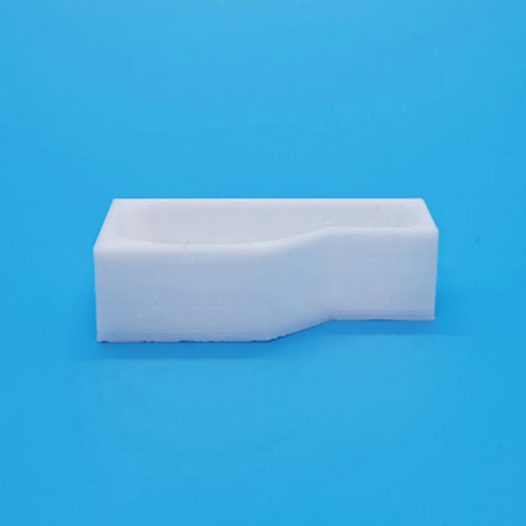 Miniature L-shaped bathtub at 1:50 scale.