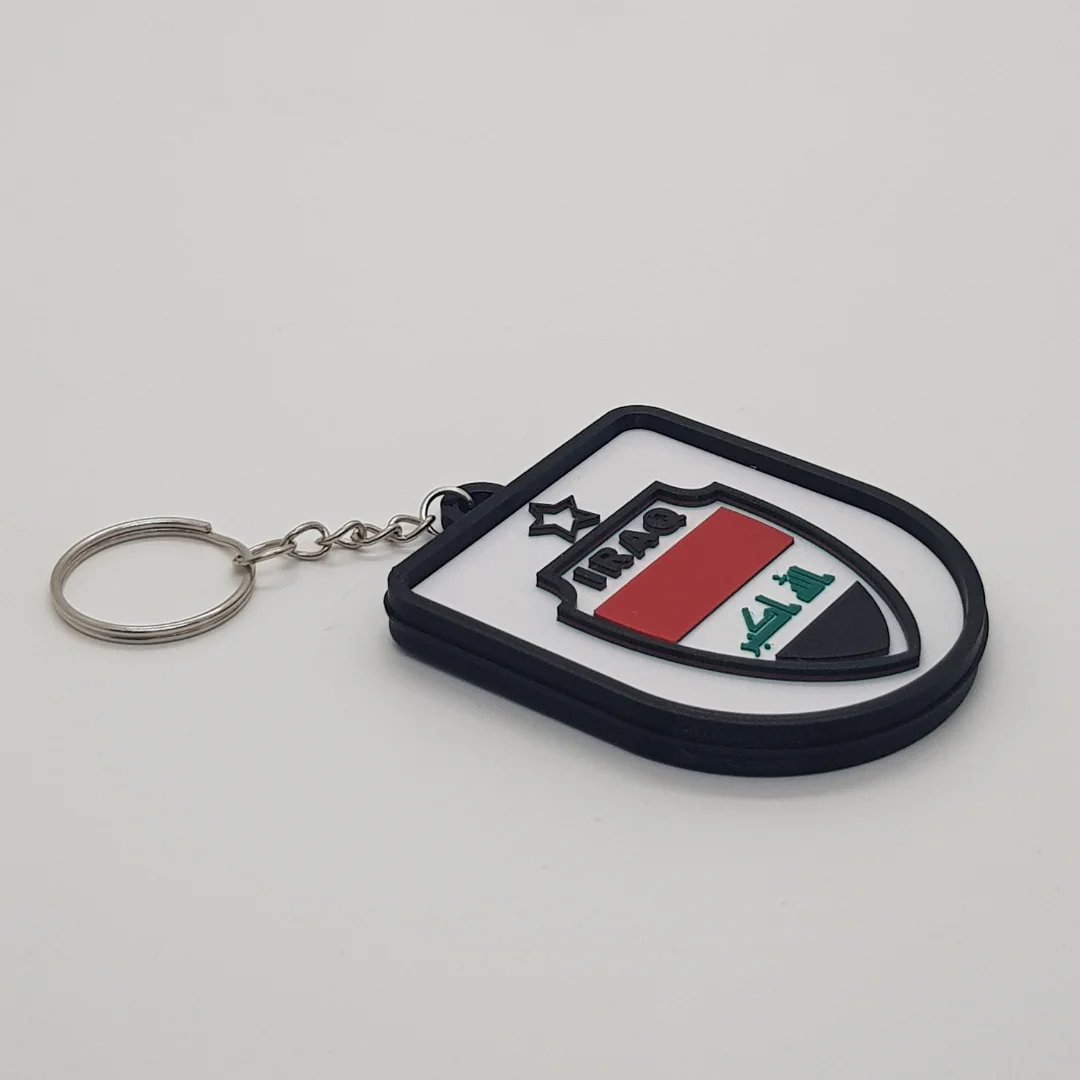Angled front view of a Iraq football keychain showing the raised crest and metal key ring.