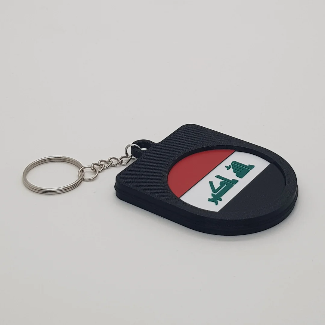 Angled rear view of a Iraq football keychain showing the national flag inset.