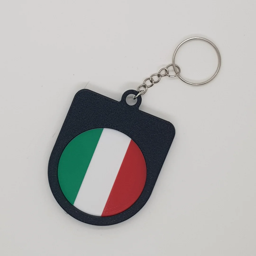 Rear view of a Italy football keychain showing the national flag.
