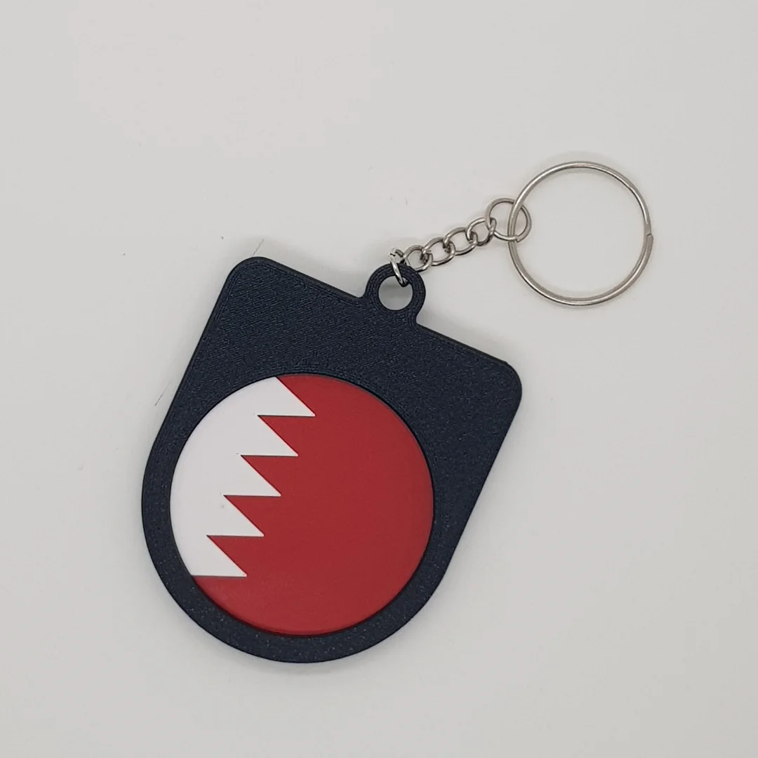 Rear view of a Bahrain football keychain showing the national flag.