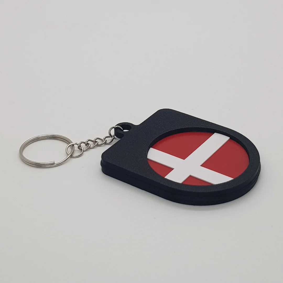Angled rear view of a Denmark football keychain showing the national flag inset.