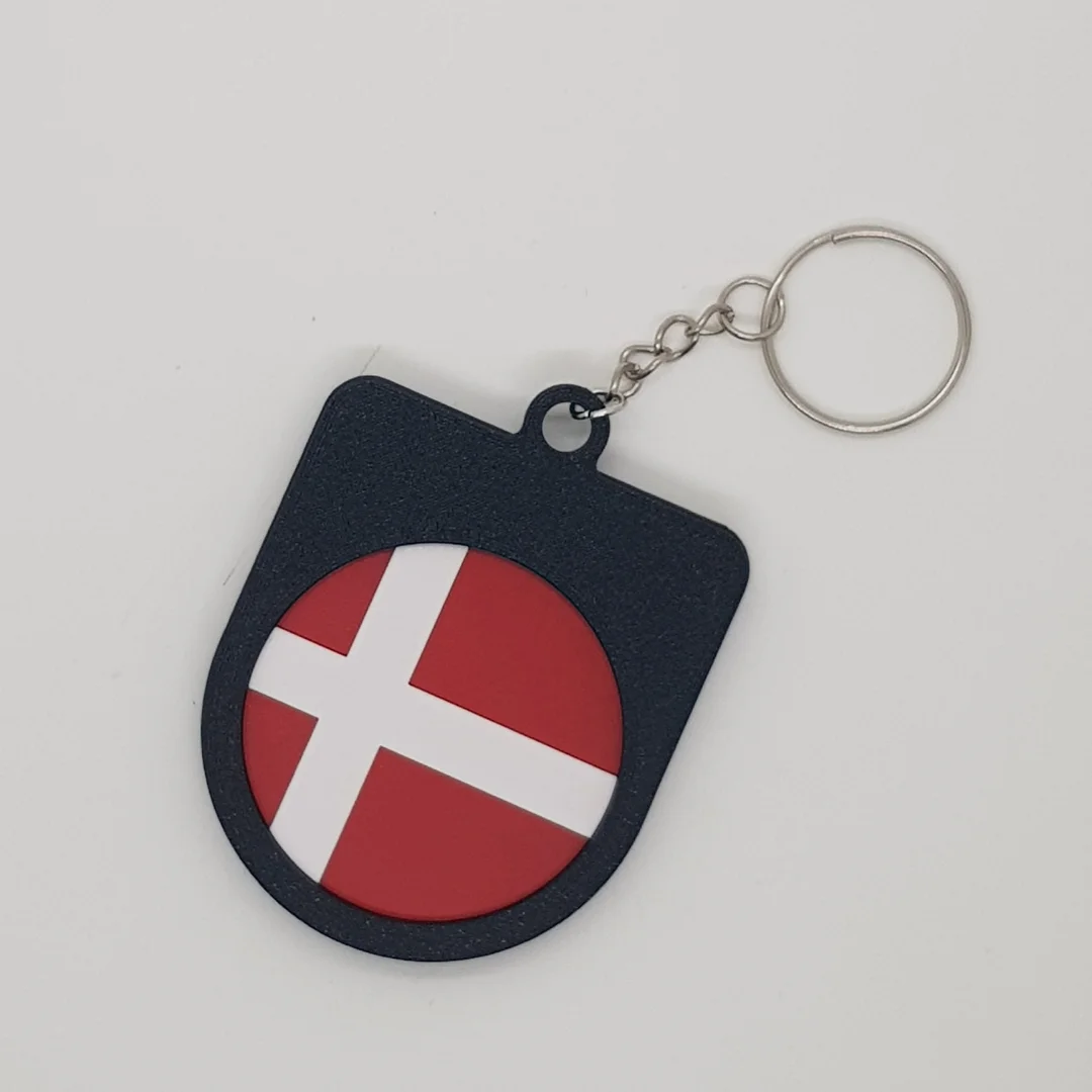 Rear view of a Denmark football keychain showing the national flag.