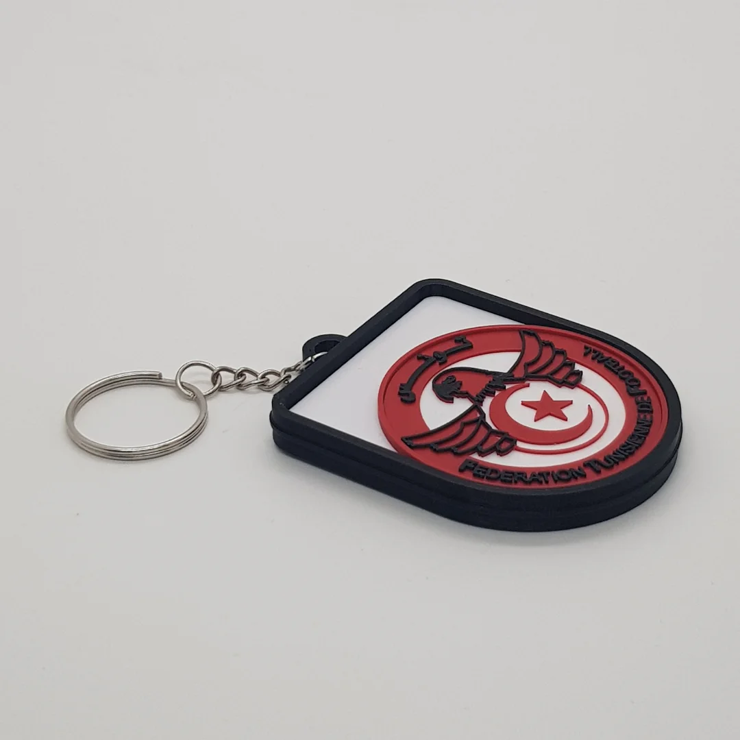 Angled front view of a Tunisia football keychain showing the raised crest and metal key ring.