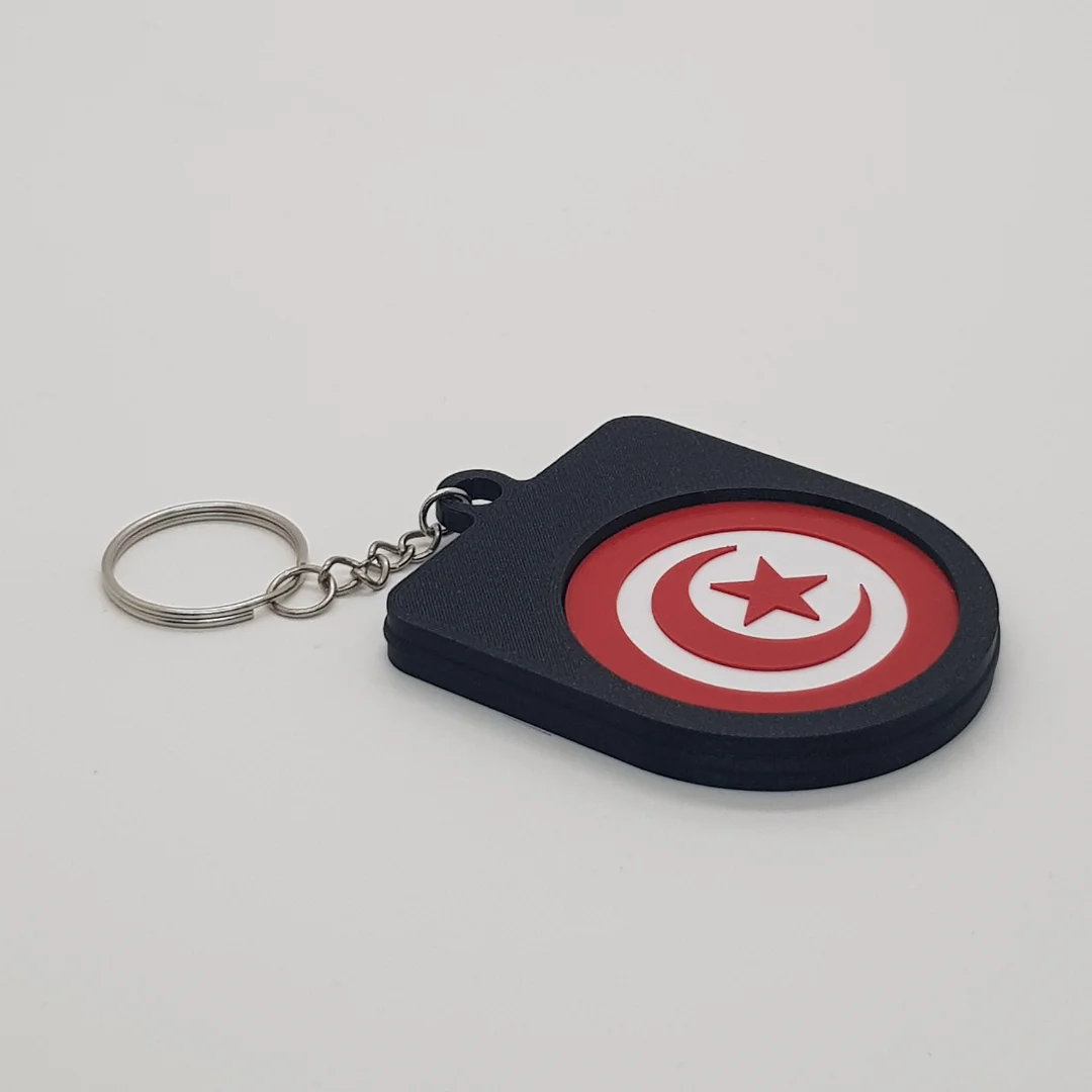 Angled rear view of a Tunisia football keychain showing the national flag inset.