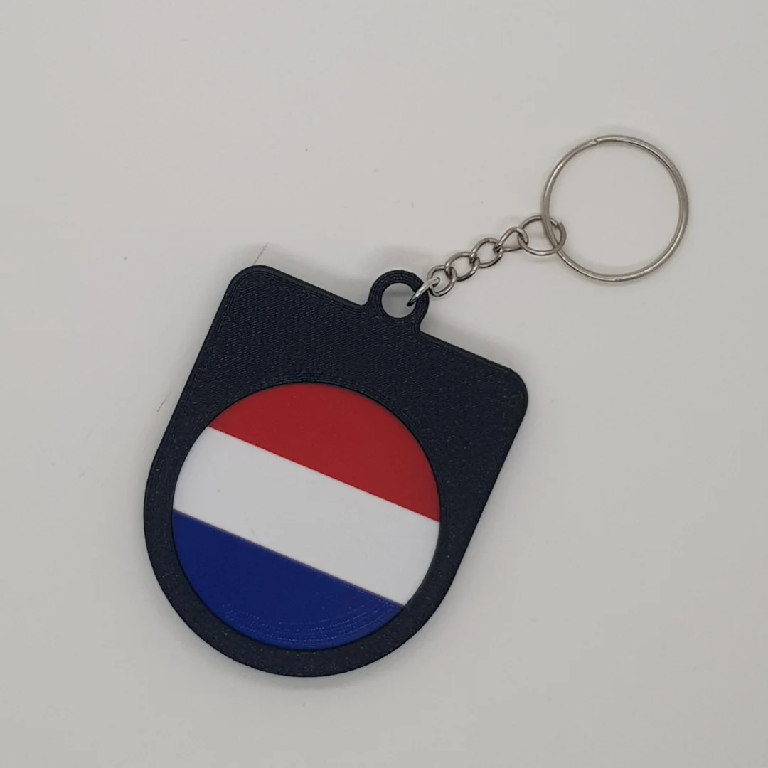 Rear view of a Netherlands football keychain showing the national flag.