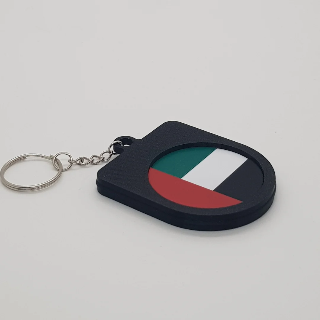 Angled rear view of a UAE football keychain showing the national flag inset.