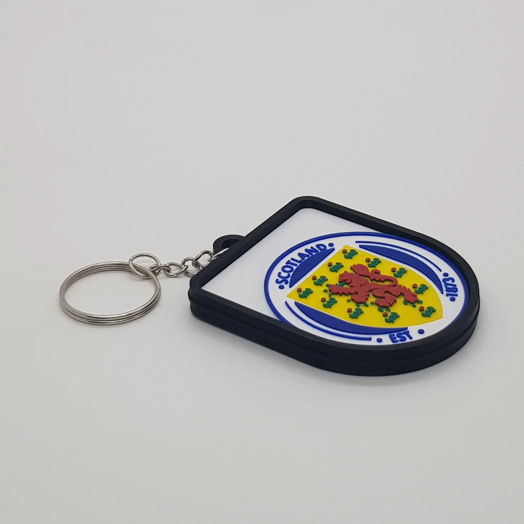 Angled front view of a Scotland football keychain showing the raised crest and metal key ring.