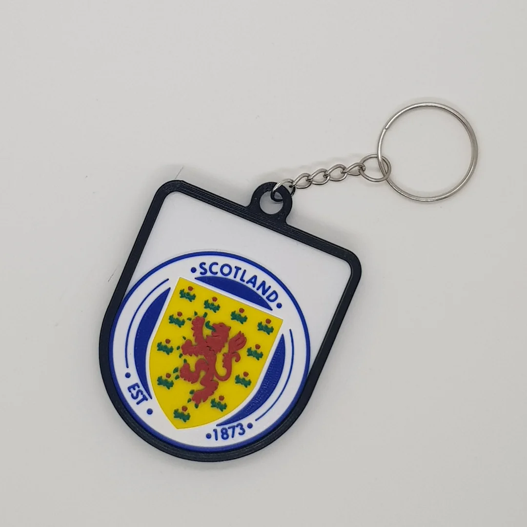 Front view of a Scotland football crest keychain with its chain and key ring.