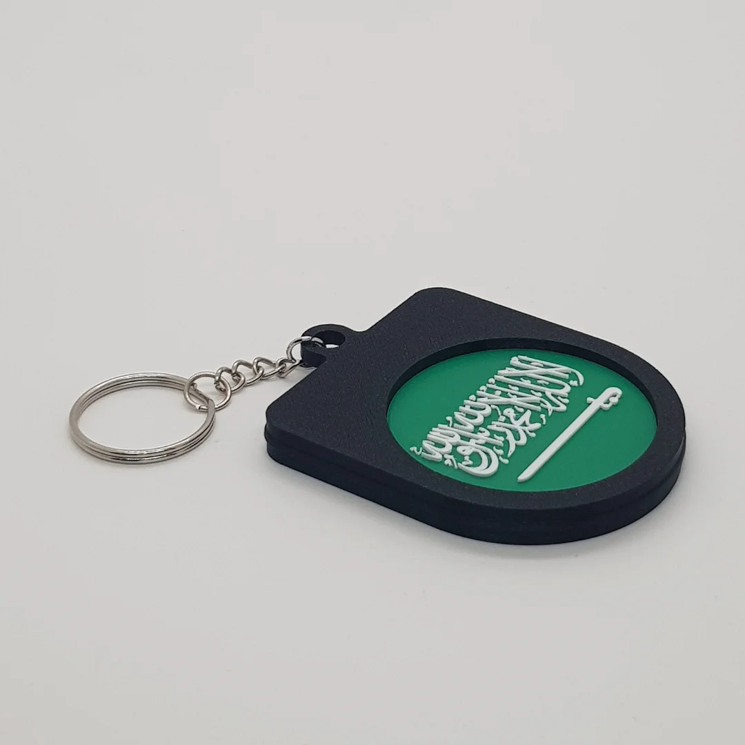 Angled rear view of a Saudi Arabia football keychain showing the national flag inset.
