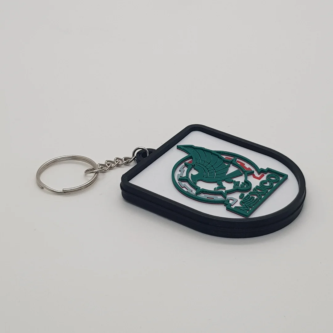 Angled front view of the Mexico football keychain showing its crest and metal key ring.