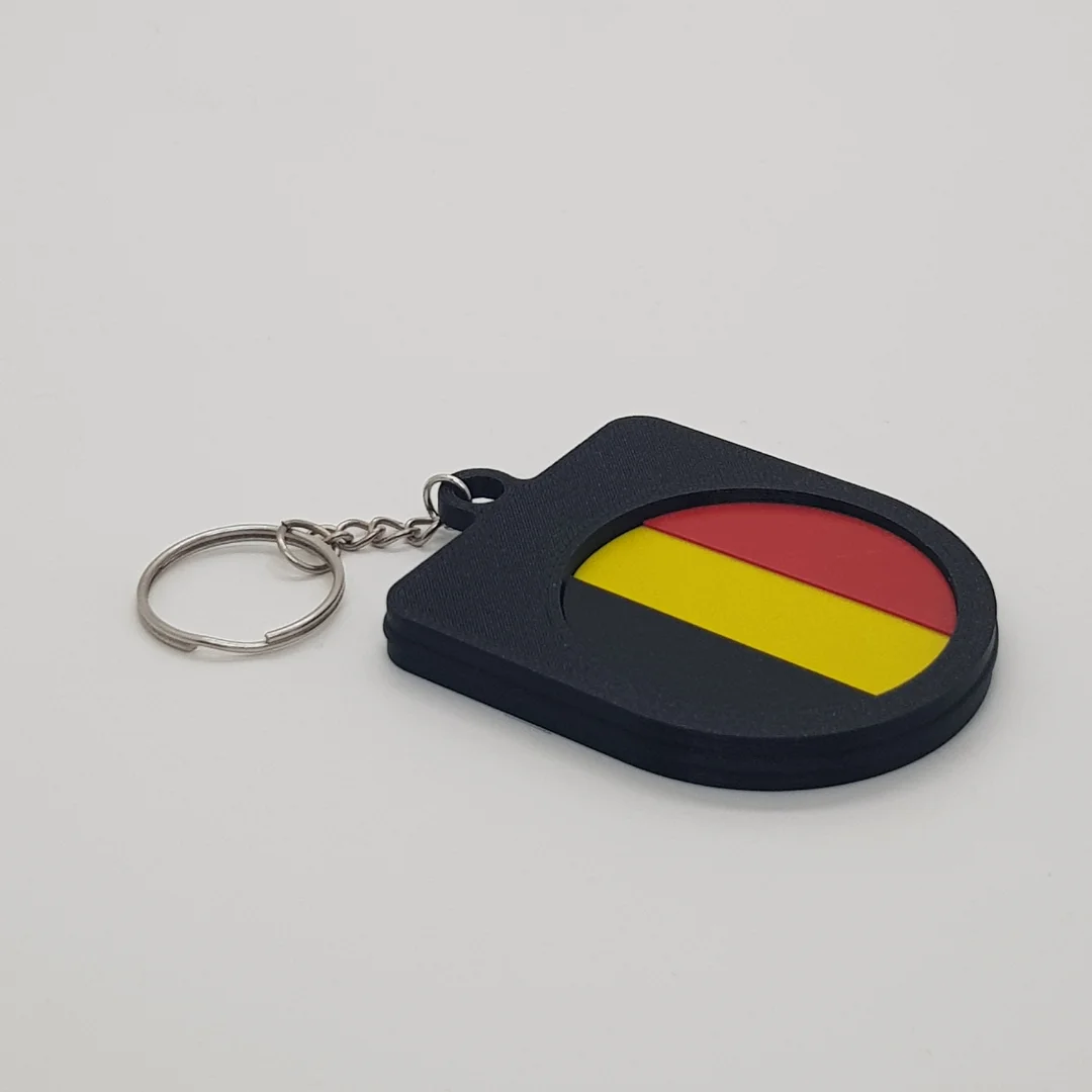 Angled rear view of the Belgium football keychain showing the national flag inset.