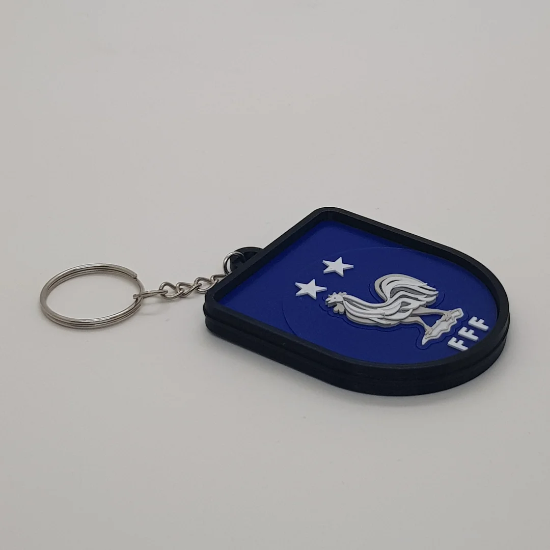 Angled front view of the France football keychain showing its crest and metal key ring.