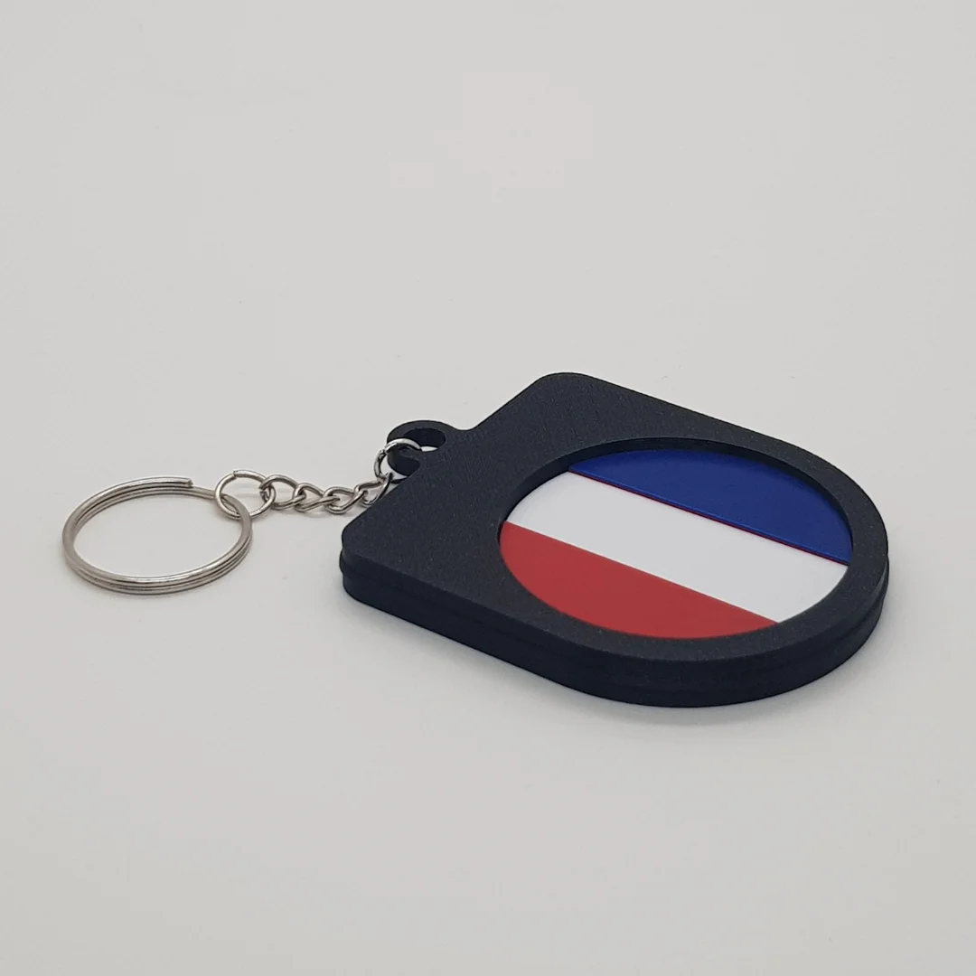 Angled rear view of the France football keychain showing the national flag inset.