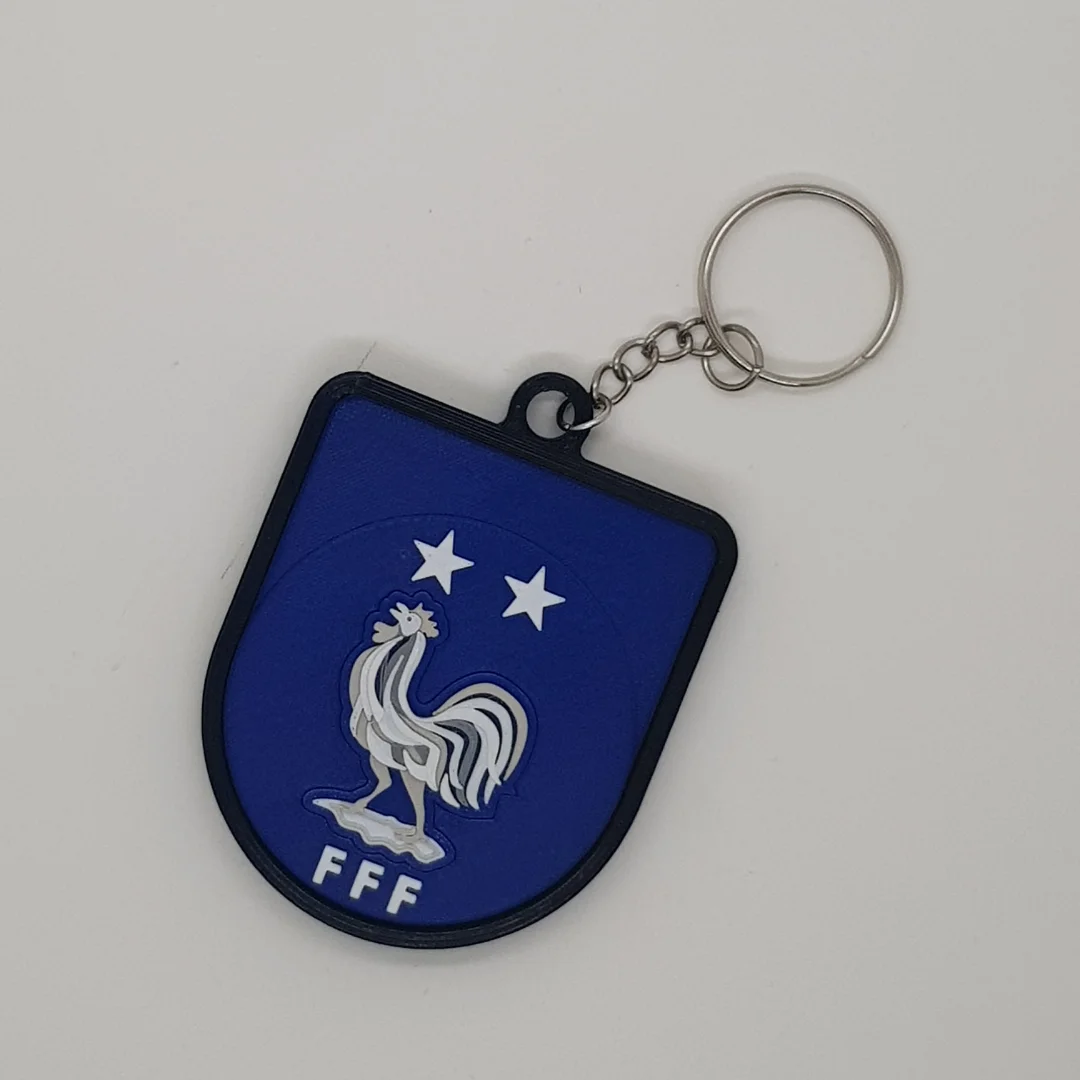 Front view of the France football crest keychain with its chain and key ring.