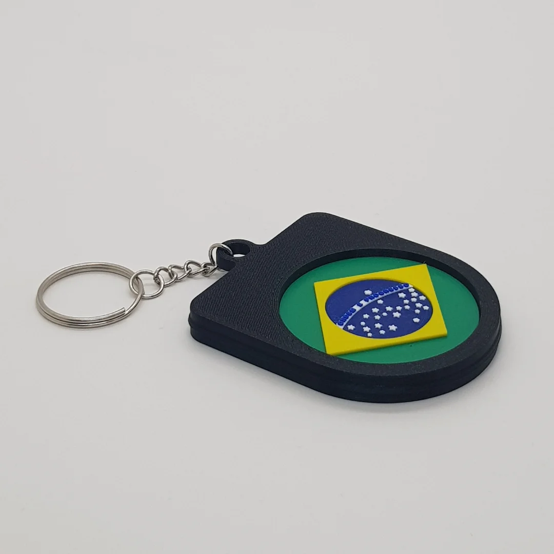 Angled rear view of the Brazil football keychain showing the national flag inset.