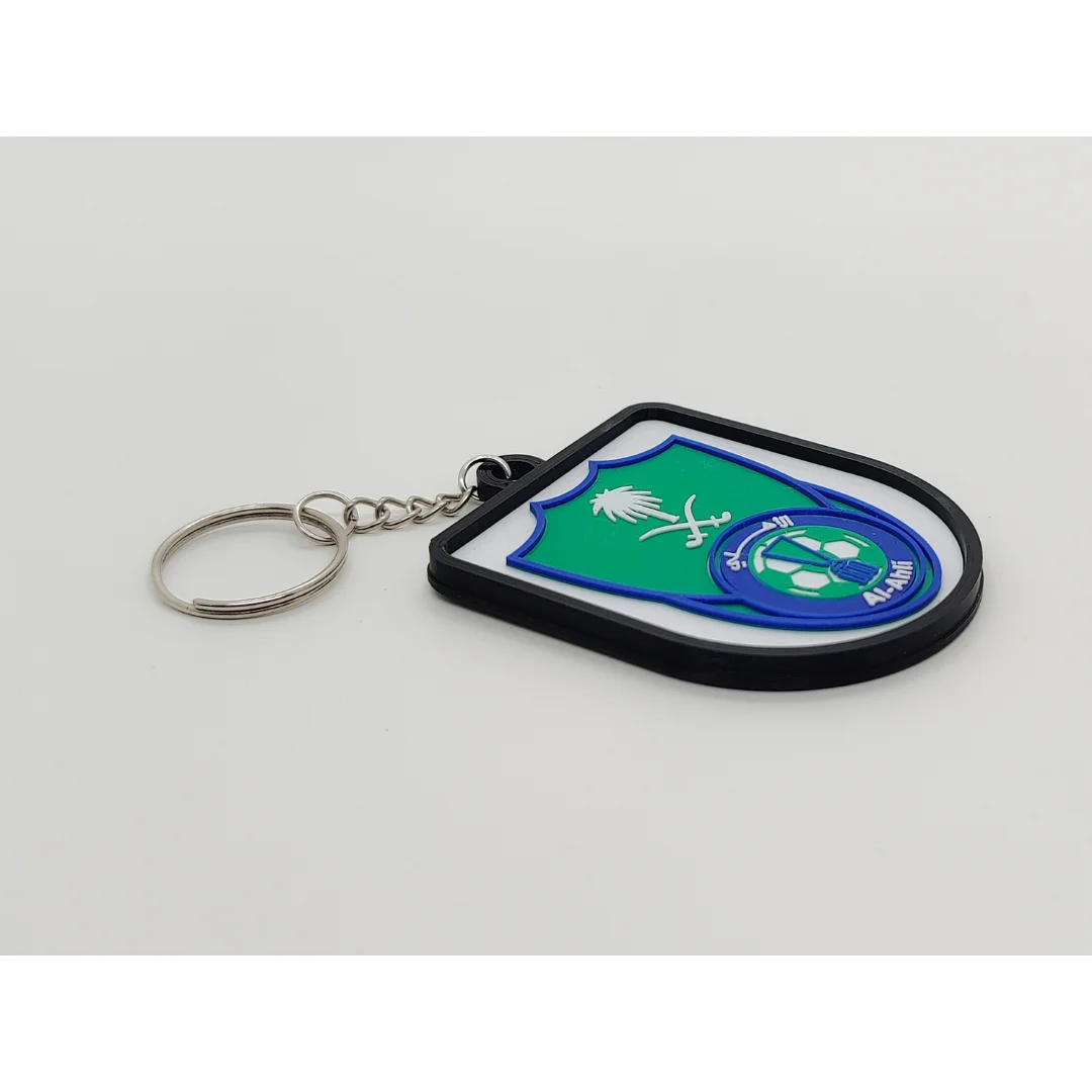 Angled view of the Al-Ahli Saudi FC keychain showing the club crest and metal key ring.