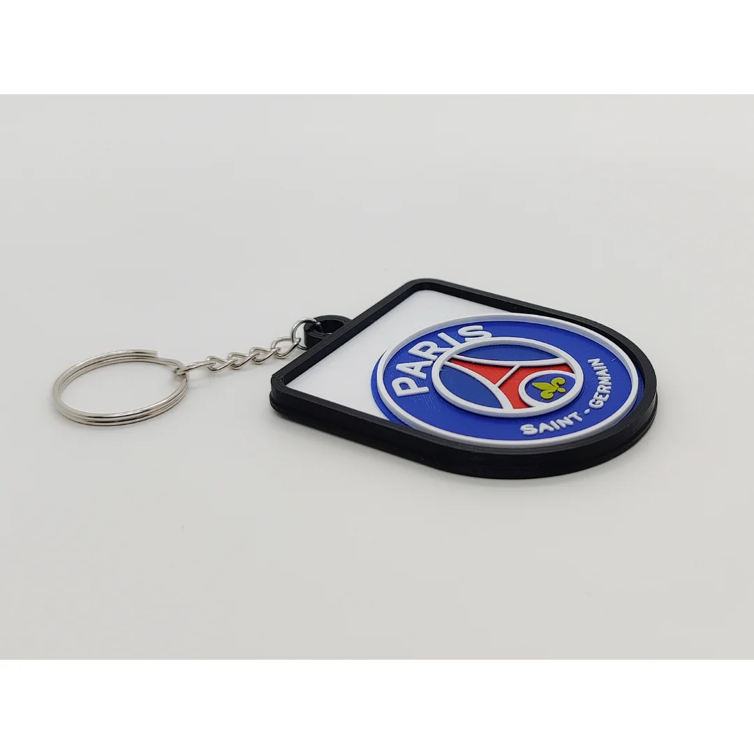 Angled view of the Paris Saint-Germain keychain showing the club crest and metal key ring.