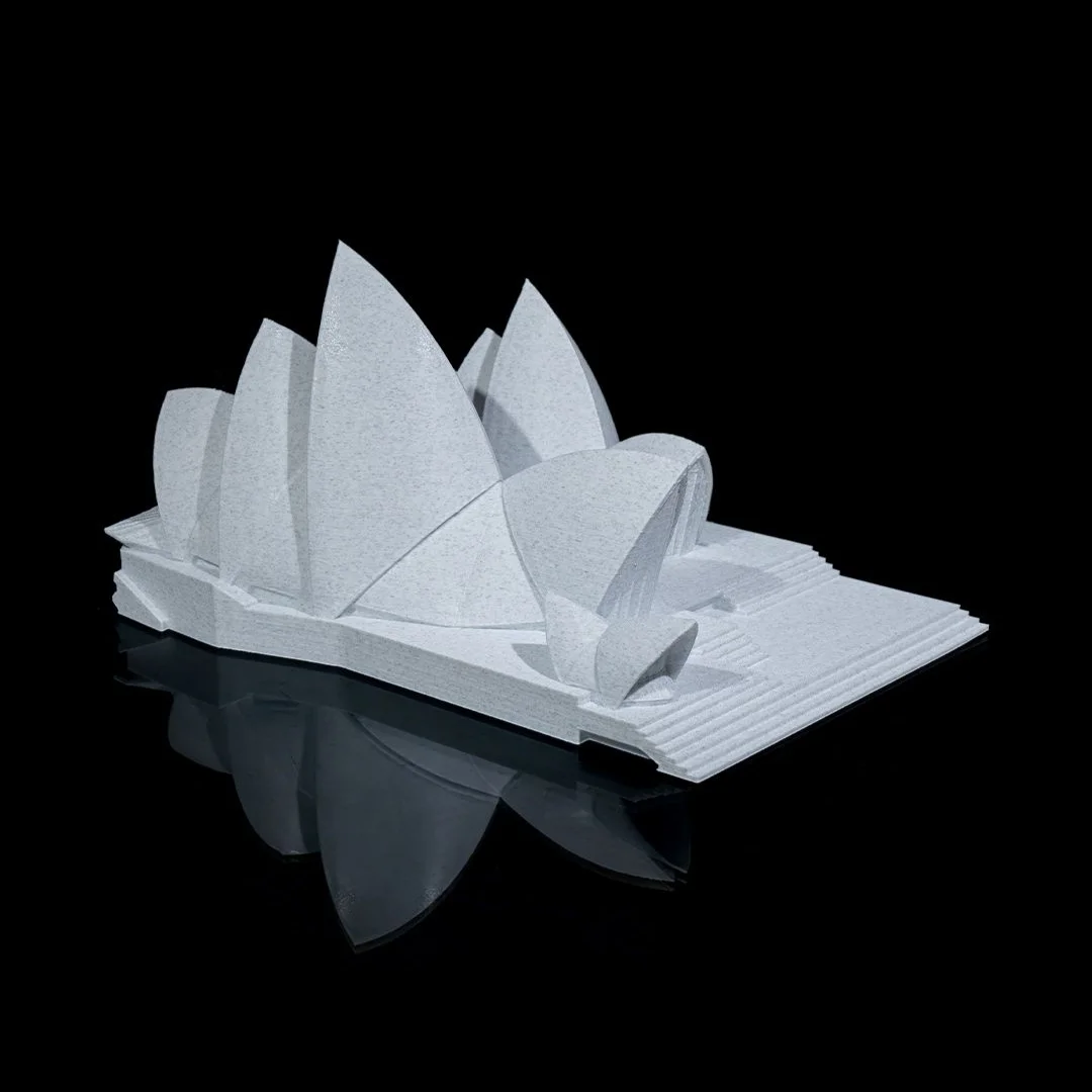 Rear angled view of a Sydney Opera House model and its stepped base.