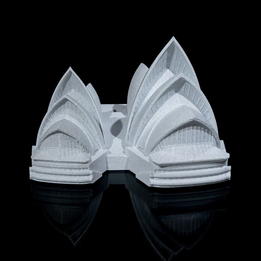 End view of a Sydney Opera House model showing the arched glazed facades.