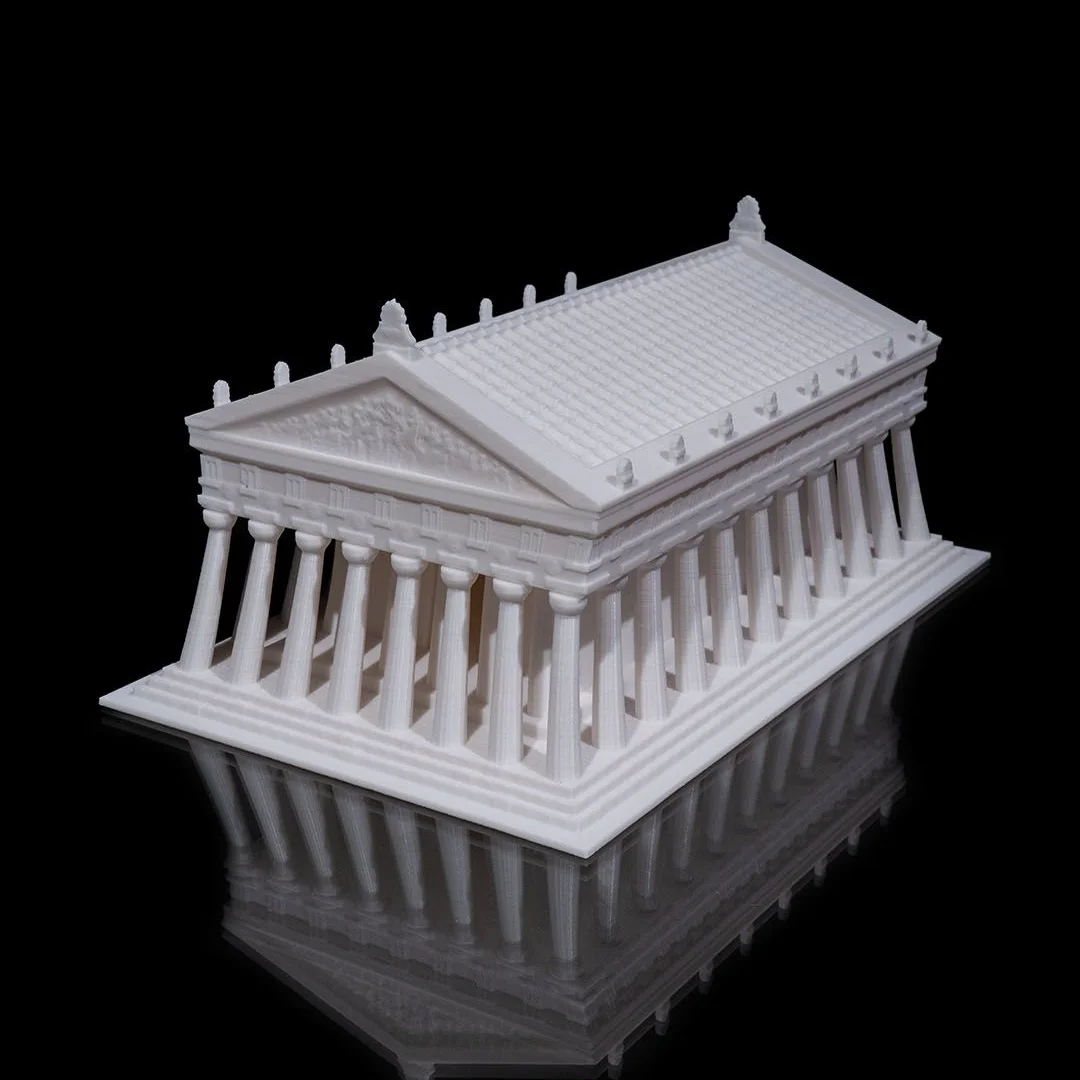 Angled view of a Parthenon model showing its columns and pediment.