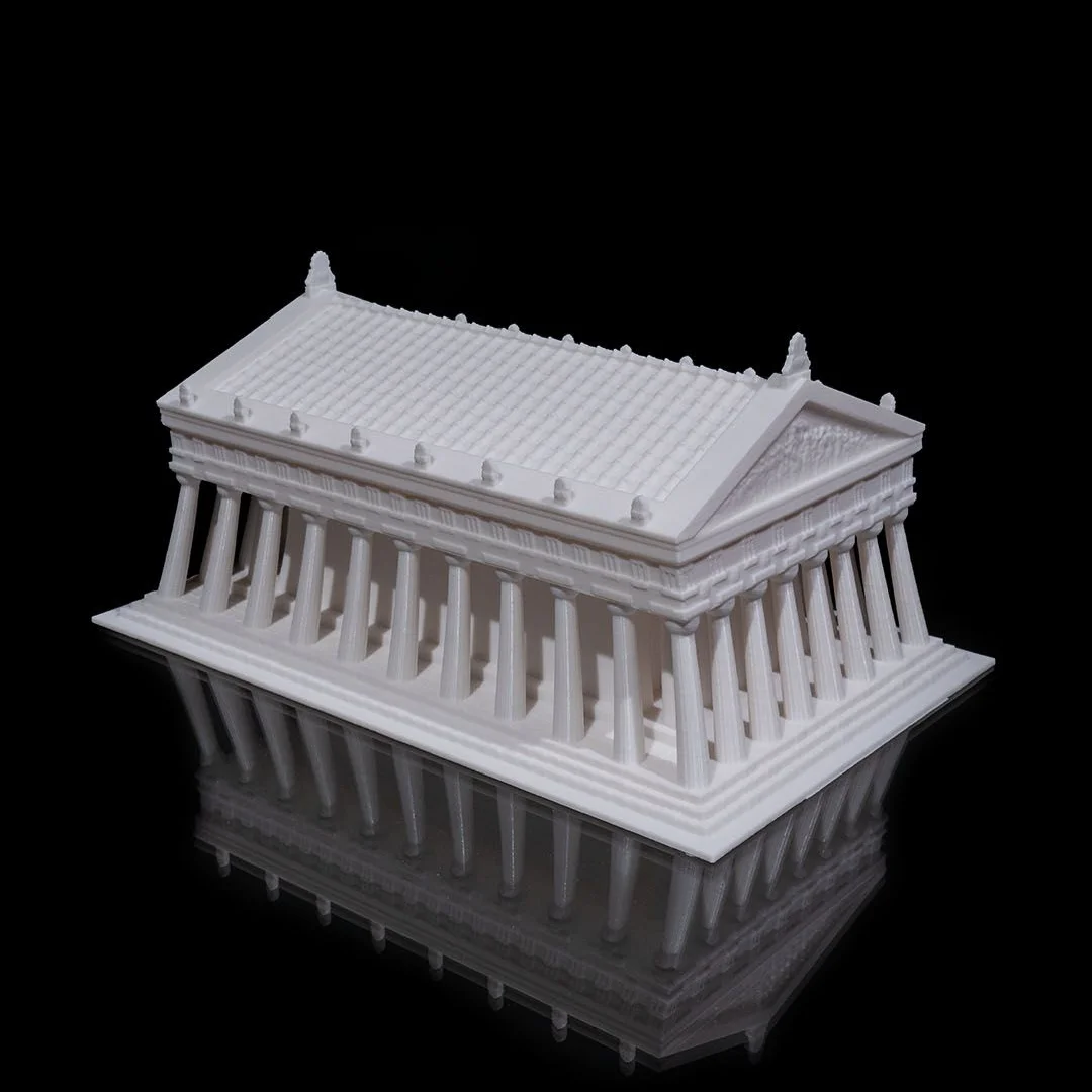 Side angled view of a Parthenon model showing the surrounding colonnade.