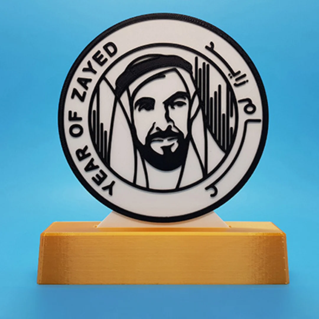 Front view of a Year of Zayed portrait sculpture with Arabic and English lettering on a stand.