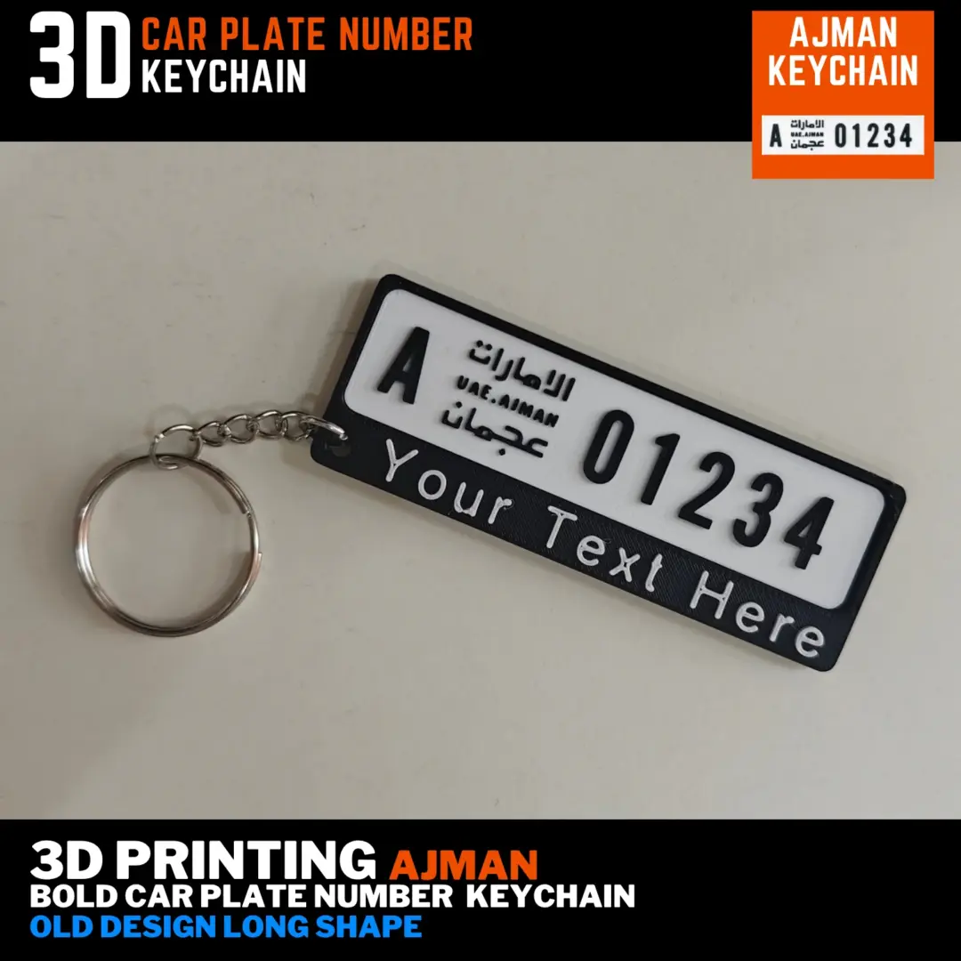 Ajman old long number plate keychain with black lettering, a custom name bar and silver split ring, shown from the front at an angle