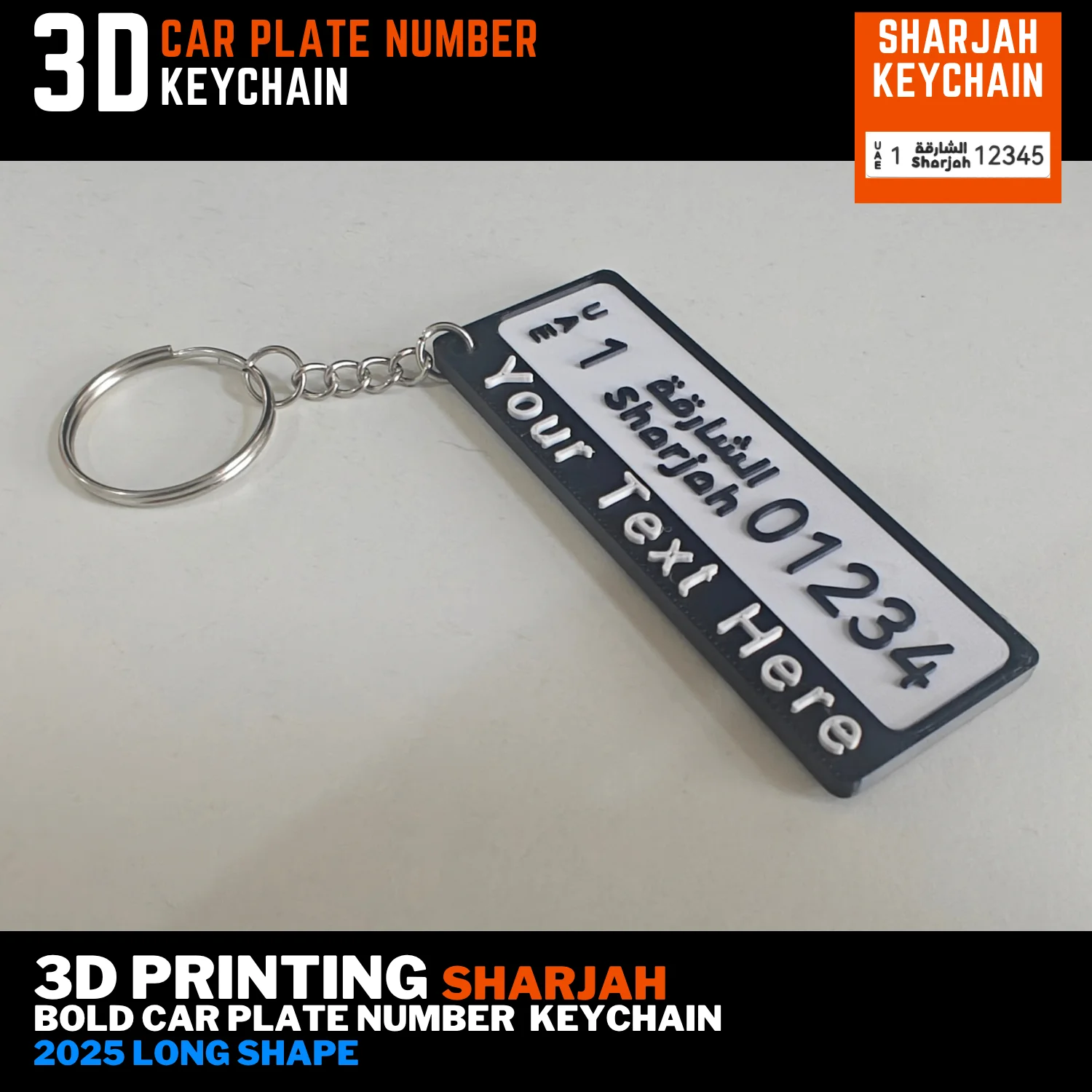 Top angled view of a Sharjah 2025 long plate keychain with a custom name bar, black border and silver split ring